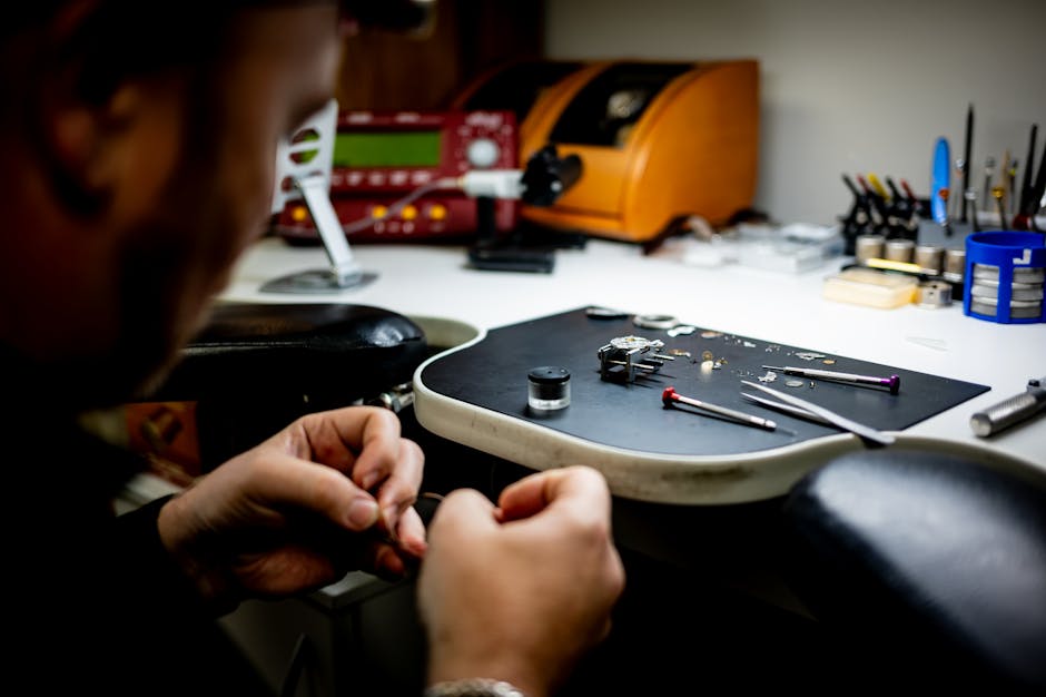 Watchmaker carefully assembling watch components on a workbench, showcasing attention to detail and craftsmanship.